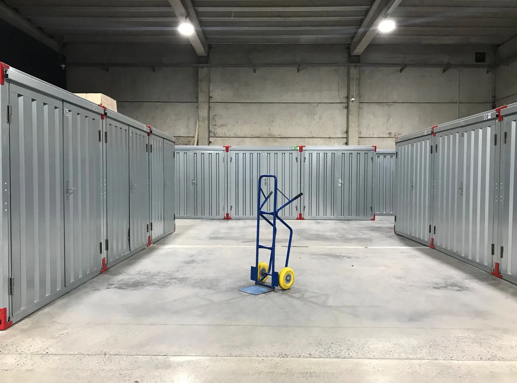 Rows of grey steel storage units inside a clean, lit warehouse